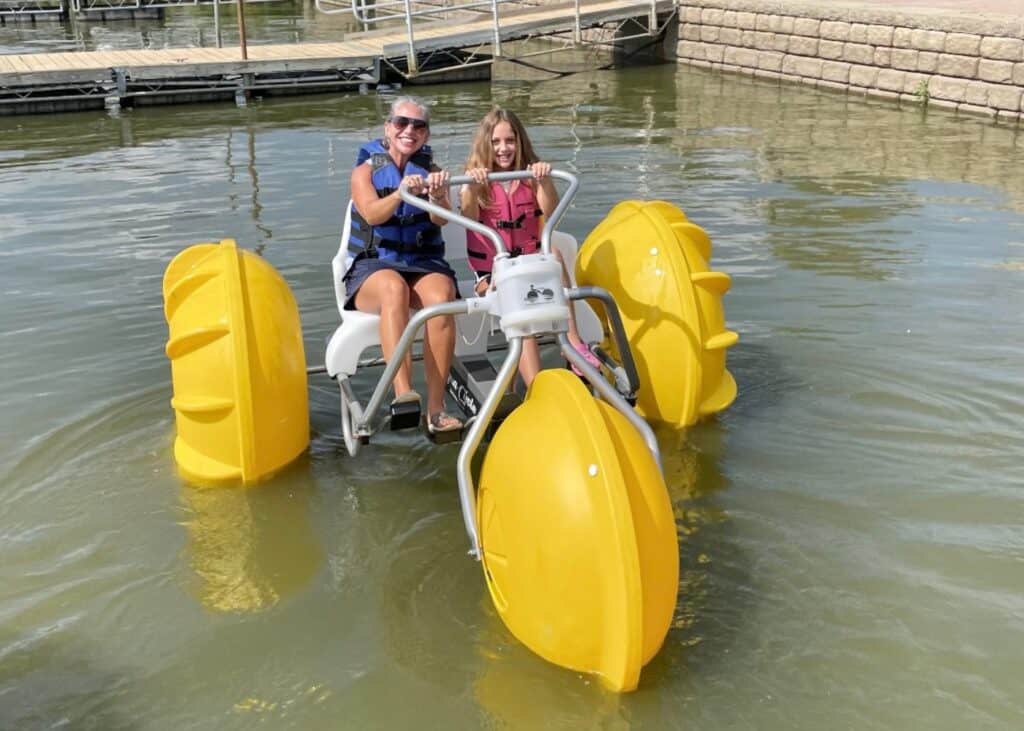 Woman and child sitting on an aqua cycle at Atwood Lake